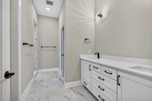 Master 3/4 Bathroom features enameled vanity cabinet, quartz countertop and dual sinks. Separate room for commode with natural light and ceramic tile flooring