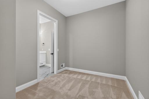 Generously sized walk-in closet with walk-through access to the Laundry Room