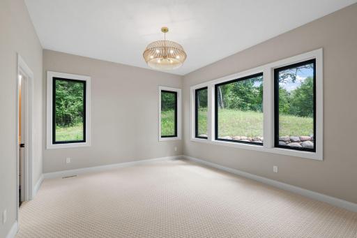 Primary Bedroom features large windows offers park views