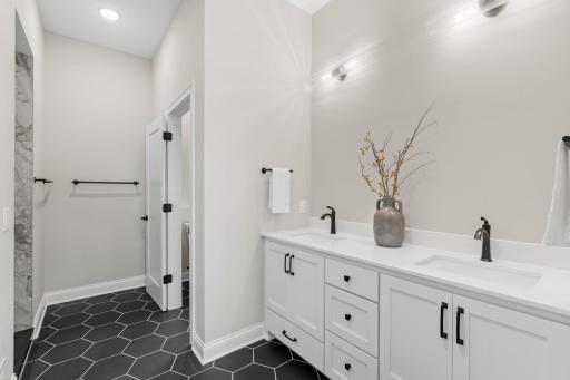 Master 3/4 Bathroom features enameled vanity cabinet, quartz countertop and dual sinks. Separate room for commode w/ natural light. Ceramic tile flooring