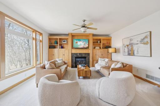 Large picture window overlooking a private, tree-lined backyard