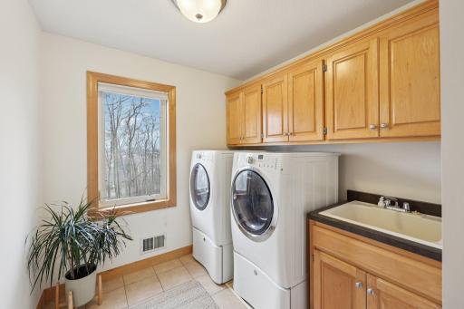 Upper-level laundry room with abundant storage is an added convenience