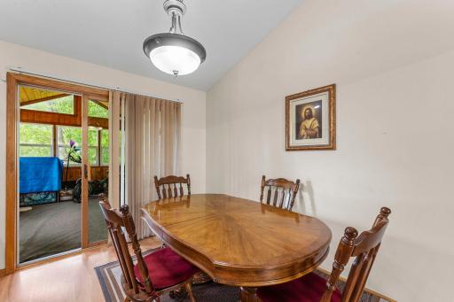 Dining walks out to large, vaulted, porch/sunroom that walks out to the deck.