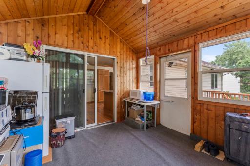 Vaulted sun room porch walks out to the large 15X11 deck