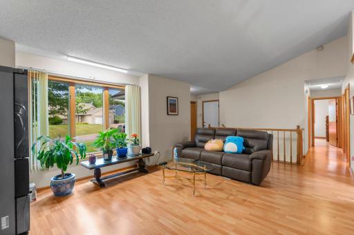 Wood floors on main level including kitchen, hallway, and main floor bedrooms. Vaulted living room with large picture window gives abundant natural lighting