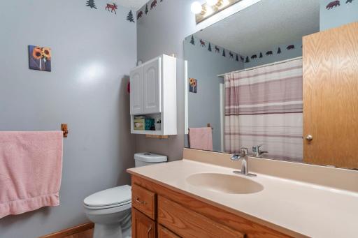 Full bathroom in hallway with shower & tub and wide vanity