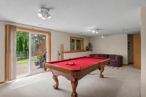 Lower level walkout family room with 15X11 patio adjacent to deck stairs landing. Seller will leave the pool table and equipment for the buyer or will remove it at the buyer's option.