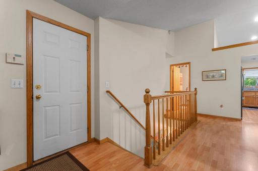 View from the wide open foyer with big closet. At left is the garage door entrance and stairs to lower level.