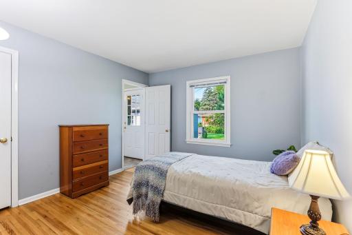 Each main-level bedroom features original hardwood flooring, offering timeless style, easy maintenance, and a warm, polished look throughout the sleeping spaces.