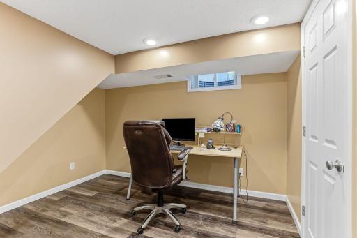 Versatile flex area finished with clean, durable laminate flooring—ideal for an office, hobbies, or a playroom with a polished, low-maintenance look.
