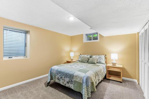 Comfortable lower-level bedroom offering privacy and flexibility, ideal for guests, teens, or extended living arrangements.