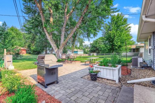 Inviting backyard patio offering a clean, open space for outdoor dining, relaxing, or entertaining—perfectly positioned to enjoy the fully fenced yard.