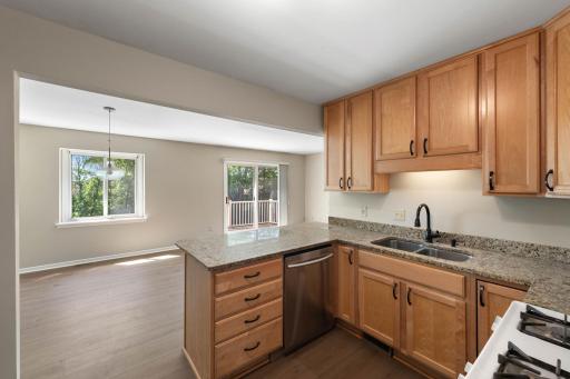 Kitchen with breakfast bar leading out to dining and den area