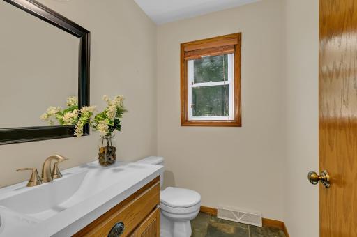 Convenient main level half bath for guests that features tiled flooring.