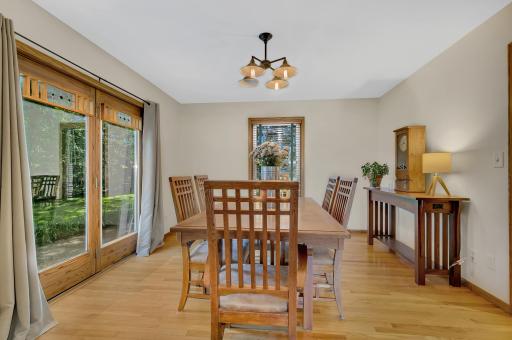 Hardwood flooring extends throughout much of the main level, complemented by tile flooring in the kitchen, dining area, and powder room.