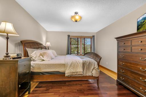 The spacious owner's suite features hardwood flooring, a walk-in closet, and a private bath.