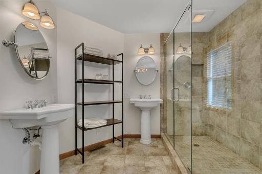 Complete with dual pedestal sinks and tiled flooring.