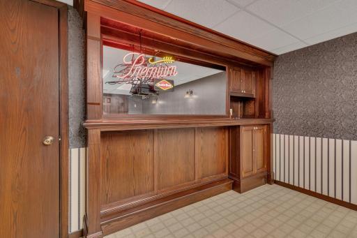 The recreation room is highlighted by a built-in display area with decorative mirror accents.