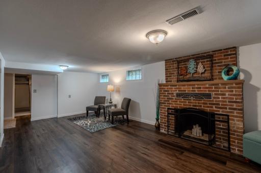 Rec room in basement with fireplace view 2