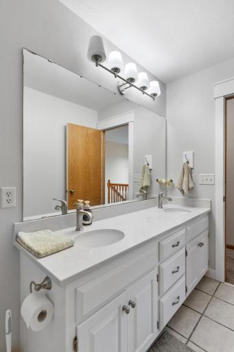 upstairs full hallway bathroom with double vanity