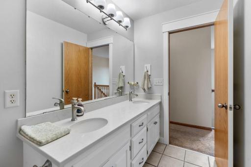 upstairs full hallway bathroom with double vanity
