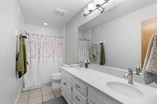 upstairs full hallway bathroom with double vanity