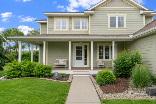 wrap around front porch with gorgeous landscaping