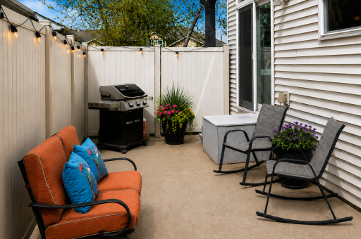 Fenced side patio -- ideal for effortless outdoor dining, barbecuing, or relaxing in the afternoon sun.