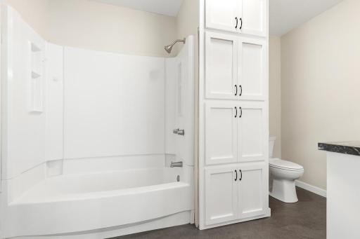 Main level full bath as-is. The built-in cabinetry offers great use of space!