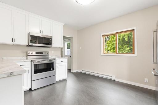 Kitchen features access to the backyard and main floor laundry