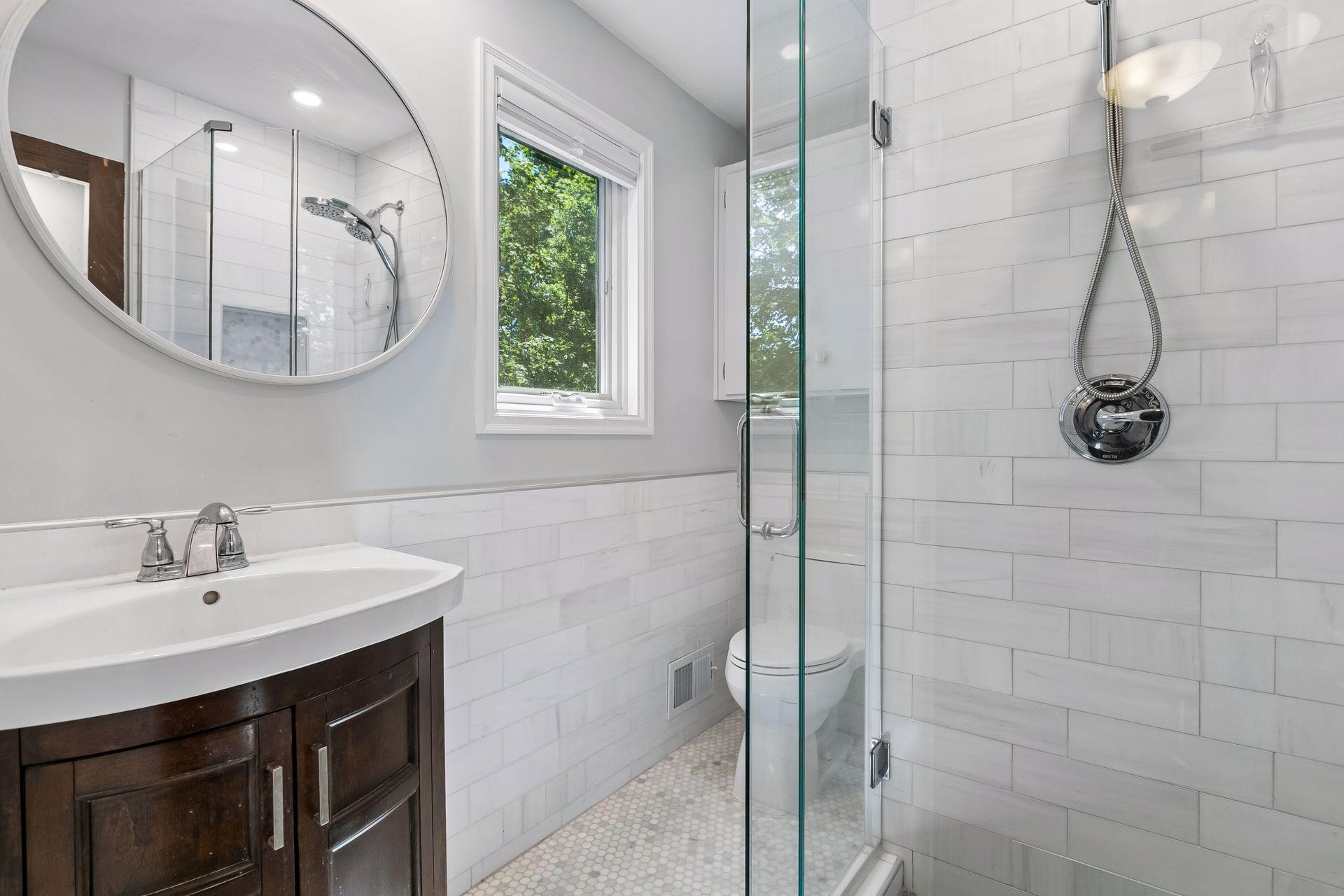 The primary bathroom was renovated in 2022 and features custom tilework.