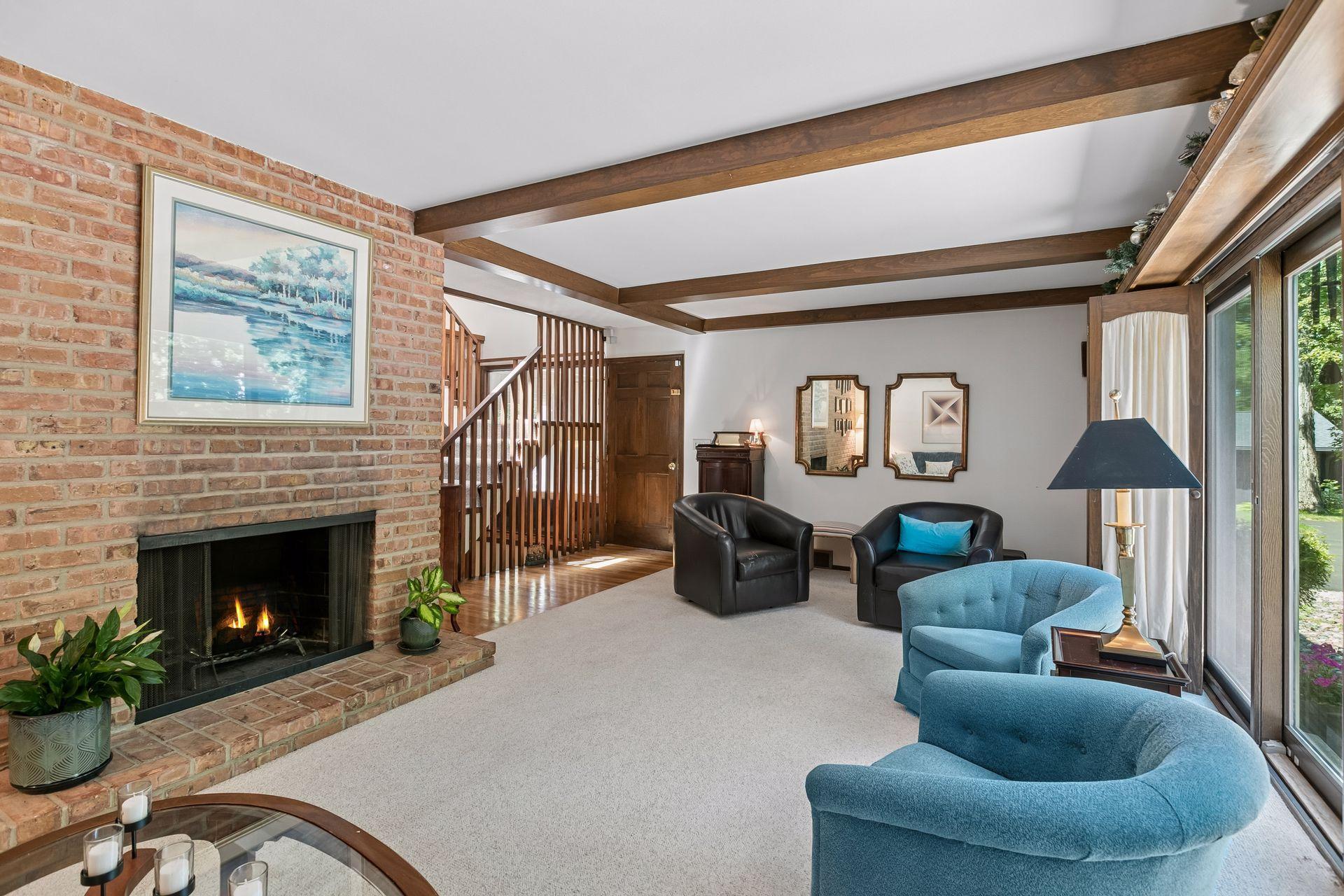 Spacious sunny living room. Note fireplaces are not in use (flames are photoshopped).
