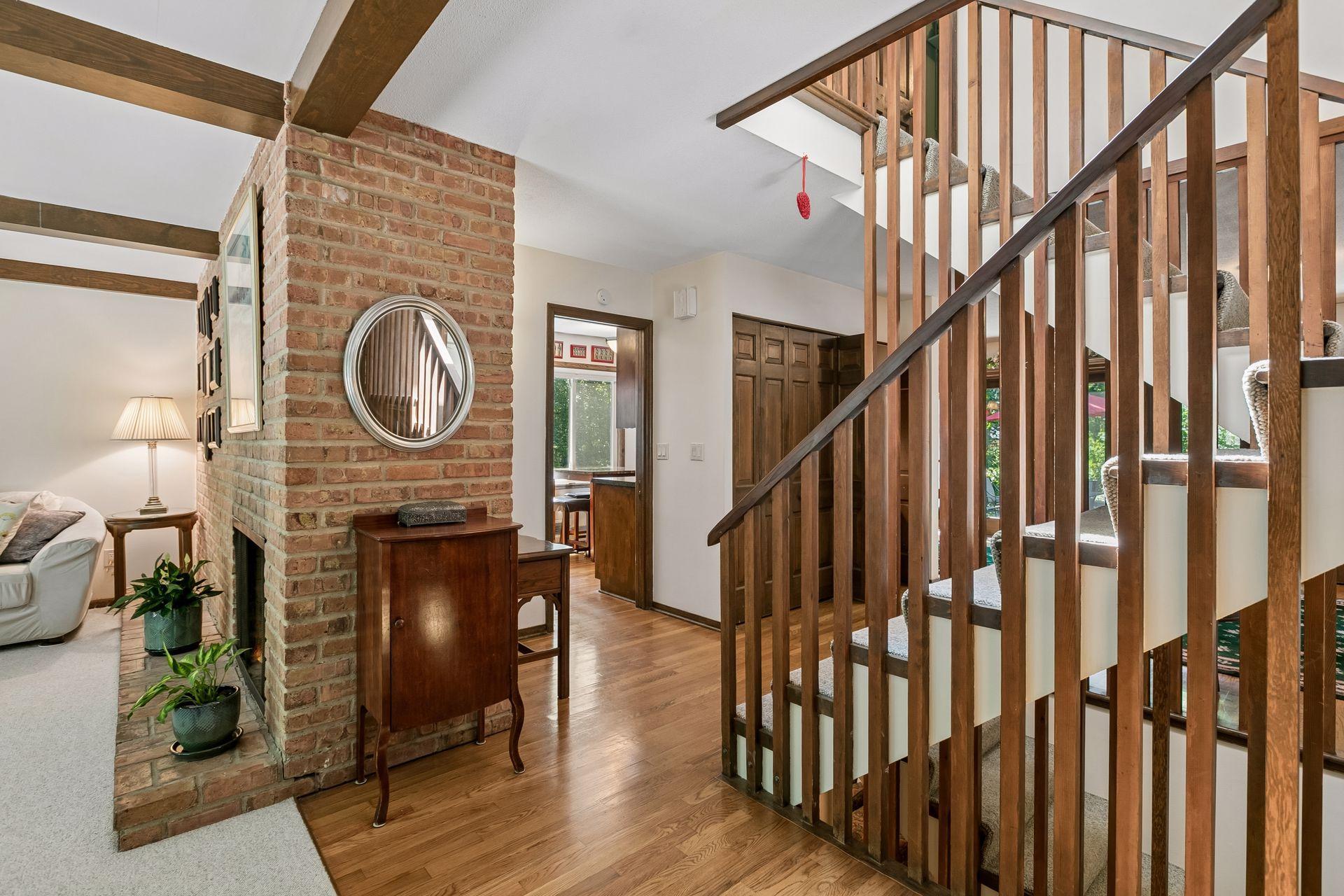 Architectural interest at every turn, from the exposed brick to the stairway spindles.