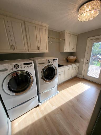 First floor laundry with door out to deck area