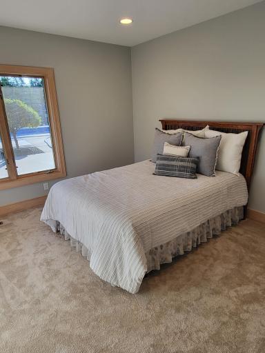 Lower level guest bedroom offers views of the pool area