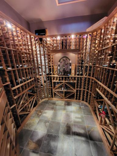 Climate controlled lower level wine room with 1000+ bottle capacity