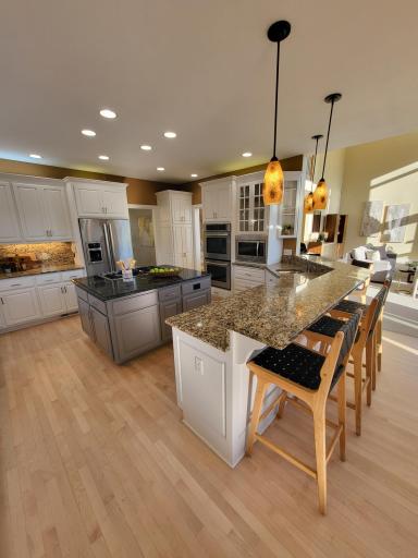 Large countertop with prep sink and raised sitting area