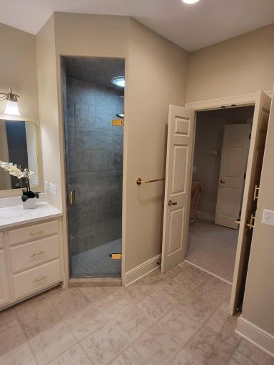 Entrance to walk-in shower and to primary bedroom area