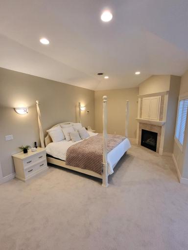 Primary bedroom with gas fireplace and media center