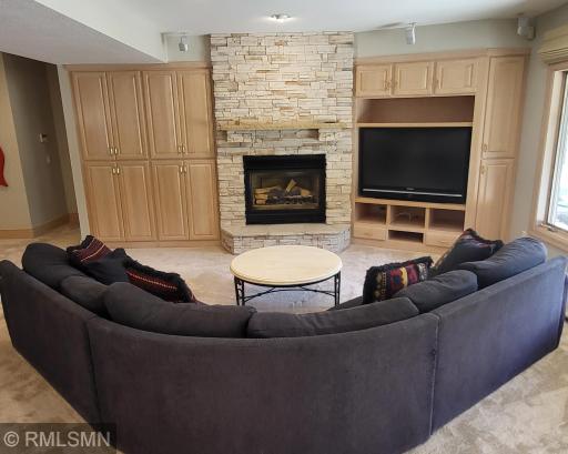 Stone gas burning fireplace and media center