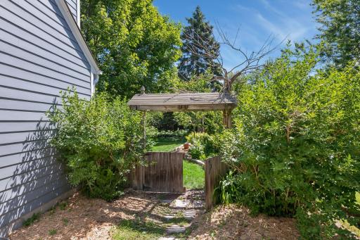 Handcrafted gazebo leads to the back yard