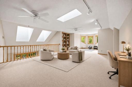 A large bonus room that overlooks the family room. Virtually staged for inspiration.