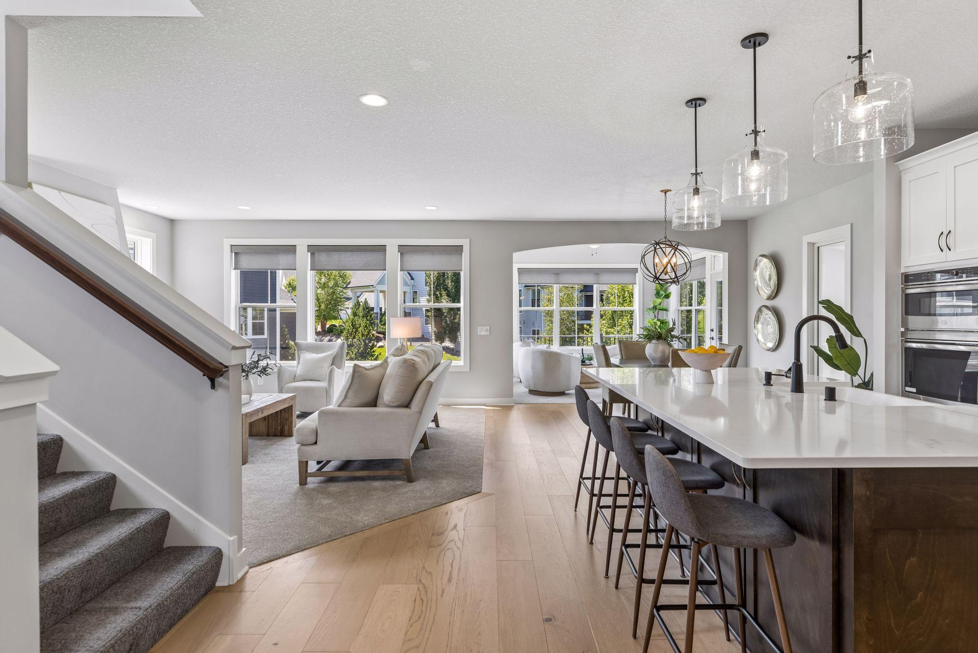 Open concept with large kitchen island and sun room