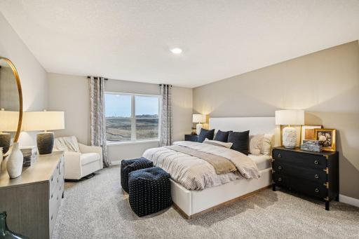Primary bedroom is spacious and provides a real retreat from the business of daily life. Pictures are of model home - actual colors and finishes may vary.