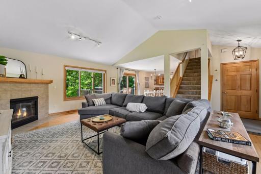 View towards informal dining, deck and kitchen. Enjoy the quality in this home with solid core Maple doors throughout.