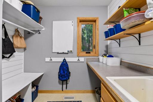 Cubby area with extra counter space and sink for home projects or assisting when folding your laundry. Great window adding sunlight to this room is always ideal.