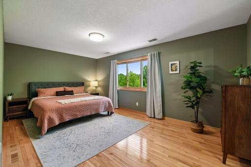 Welcome to your upper primary bedroom with maple hardwood floors and private bath.