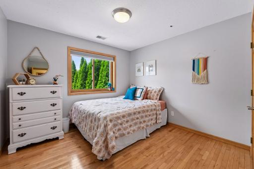 Bedroom 2 of 3 in upper level with maple hardwood floors and nice solid core panel doors to spacious closet.