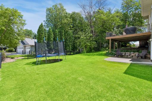 Side yard with green space to play and enjoy. Fenced yard 2016 added by seller is ideal for pets or little ones. Enjoy the walkout lower level for easy access.