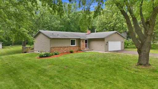 Welcoming exterior showcasing the home's attractive setting and generous lot.